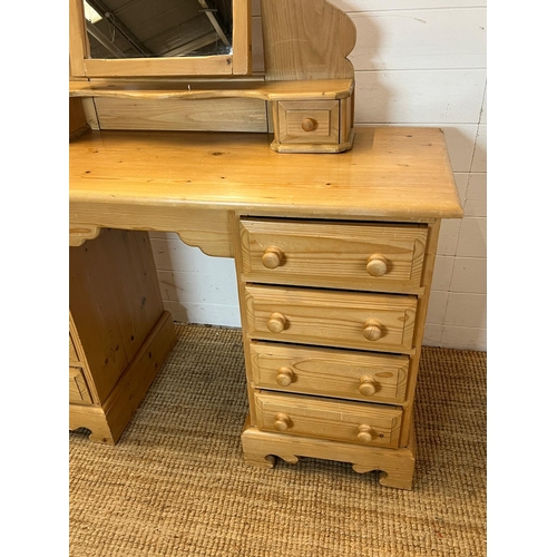 64 - A pine dressing table with four drawers each side and a pine mirror (H74cm W122cm D47cm)