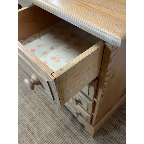 64 - A pine dressing table with four drawers each side and a pine mirror (H74cm W122cm D47cm)