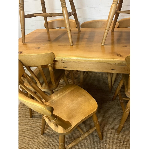 65 - A pine farmhouse table with eight chairs (H77cm W168cm D83cm)