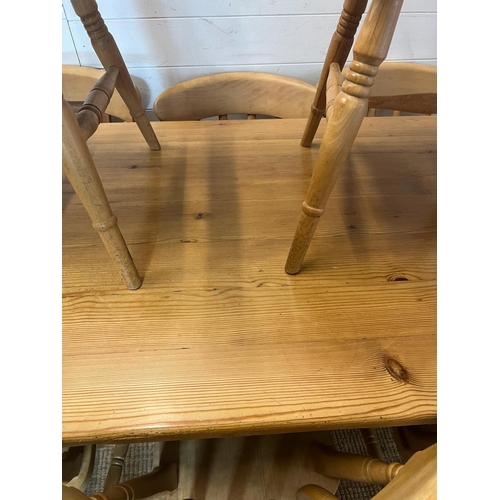 65 - A pine farmhouse table with eight chairs (H77cm W168cm D83cm)