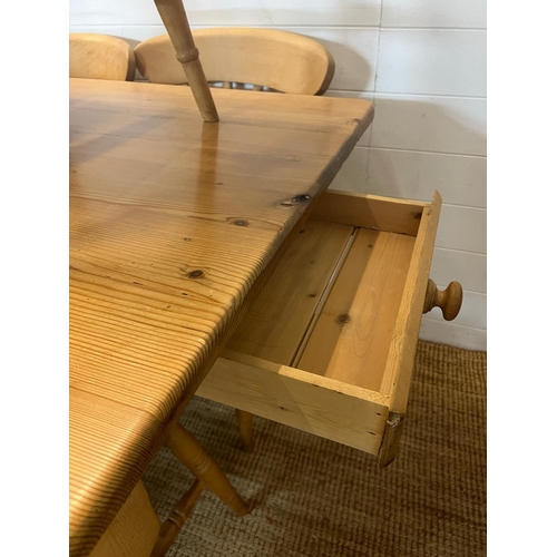 65 - A pine farmhouse table with eight chairs (H77cm W168cm D83cm)