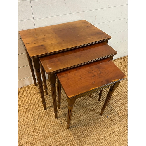 67 - A nest of three table on fluted legs (H54cm W56cm D38cm)