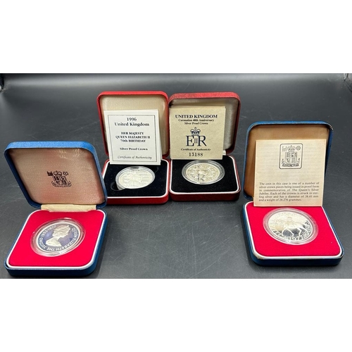 688 - A selection of four silver proof crown coins, two Silver Jubilee, 40th anniversary of the Coronation... 