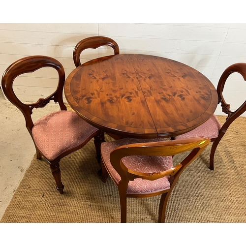 76 - Circular dining table on down swept legs and metal capped lion paw ends with four balloon back chair... 