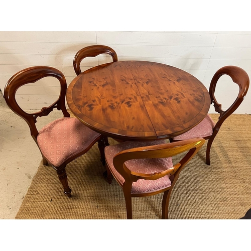 76 - Circular dining table on down swept legs and metal capped lion paw ends with four balloon back chair... 