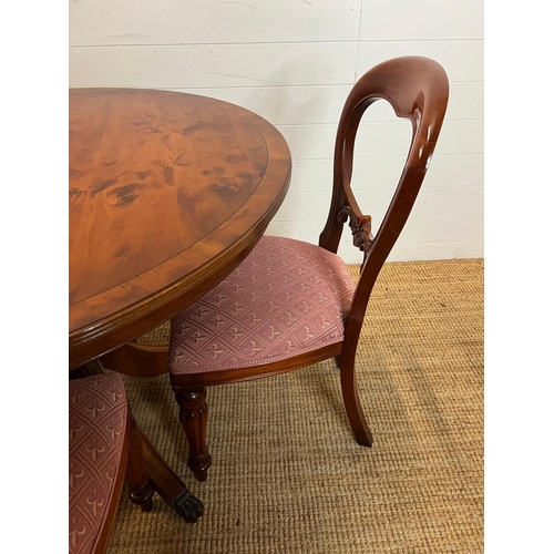 76 - Circular dining table on down swept legs and metal capped lion paw ends with four balloon back chair... 