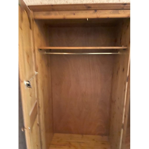 77 - A triple pine Ducal wardrobe