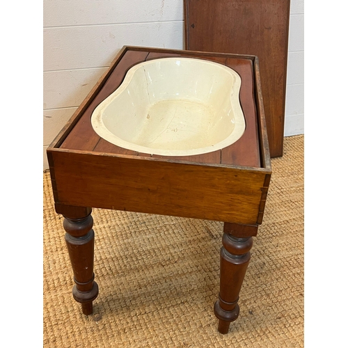 79 - A mahogany framed baby bath with china insert (H46cm W59cm D37cm)