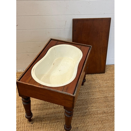 79 - A mahogany framed baby bath with china insert (H46cm W59cm D37cm)