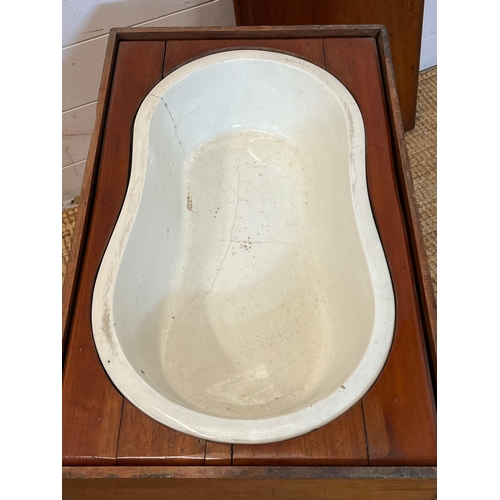 79 - A mahogany framed baby bath with china insert (H46cm W59cm D37cm)