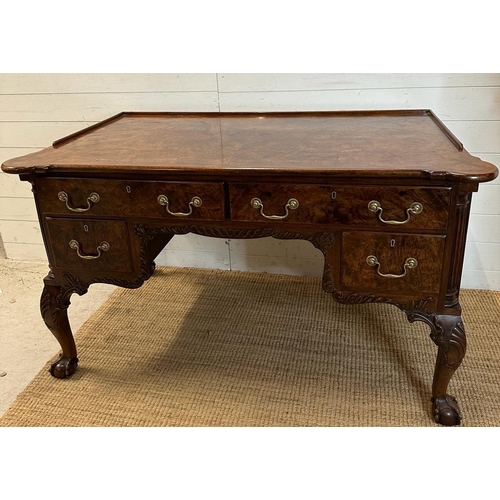 94 - a Georgian style walnut knee hole desk with brass drop handles and galleried top on claw and ball fe... 