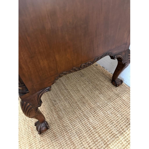 94 - a Georgian style walnut knee hole desk with brass drop handles and galleried top on claw and ball fe... 