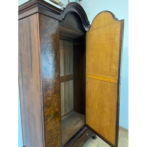 11 - A Victorian mahogany wardrobe with arched hood, the panelled inlaid sides with centre mirrored doors... 