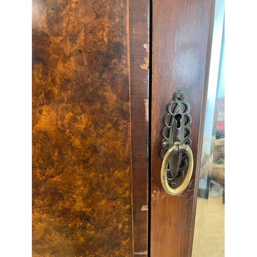 11 - A Victorian mahogany wardrobe with arched hood, the panelled inlaid sides with centre mirrored doors... 