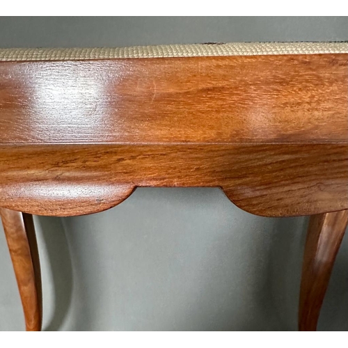 113 - A wooden framed piano stool with a scrolling upholstered seat