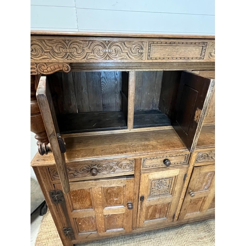 13 - A light oak buffet court cupboard, three panelled doors top and bottom (H139cm W140cm D54cm)