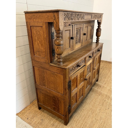 13 - A light oak buffet court cupboard, three panelled doors top and bottom (H139cm W140cm D54cm)