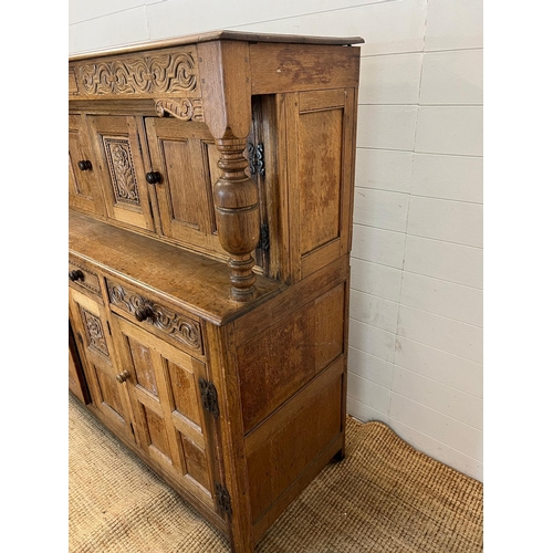 13 - A light oak buffet court cupboard, three panelled doors top and bottom (H139cm W140cm D54cm)