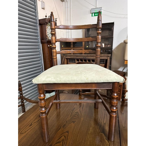 134 - An oak extendable dining table and eight chairs to include two carvers (H73cm W180cm D104cm)