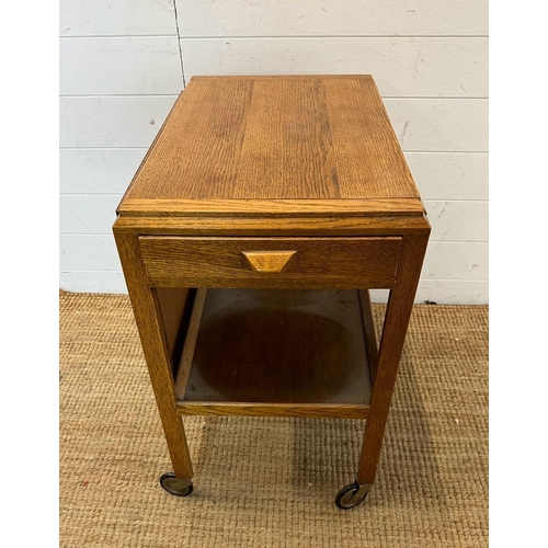 140 - A Mid Century metamorphic tea trolly and table on castors