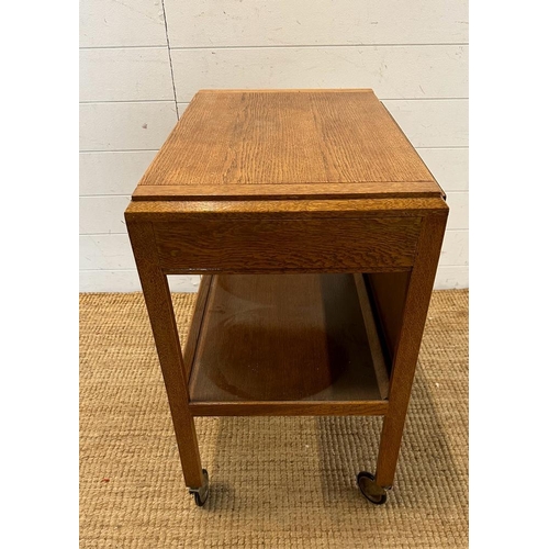 140 - A Mid Century metamorphic tea trolly and table on castors