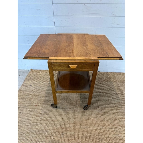 140 - A Mid Century metamorphic tea trolly and table on castors