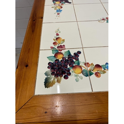 143 - A pine tiled top kitchen table (H76cm W106cm D98cm)