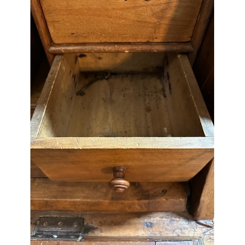 149 - A large pine bureau. The front fall opening to pigeon holes, drawers and a brown leather topped writ... 