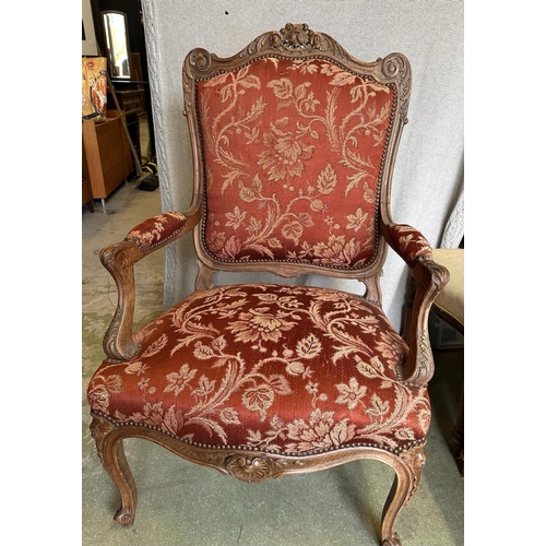 151 - A French Louis style armchair, carved oak frame and upholstered with stud detail