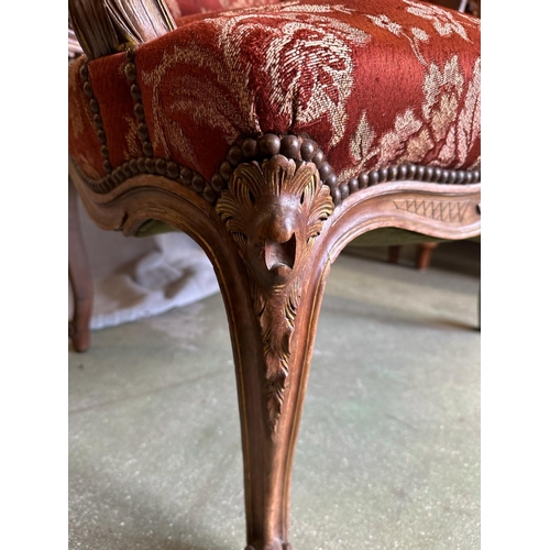 151 - A French Louis style armchair, carved oak frame and upholstered with stud detail