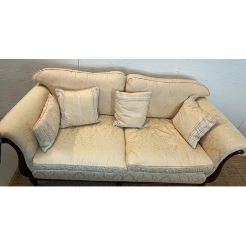 154 - A large two seater sofa with scrolling wooden frame by Medallion (H83cm W197cm D94cm SH53cm)