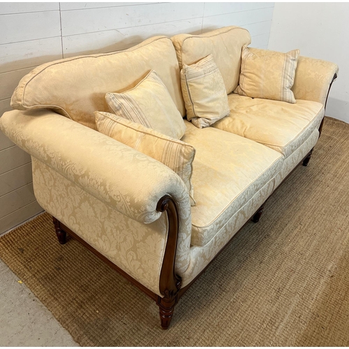 154 - A large two seater sofa with scrolling wooden frame by Medallion (H83cm W197cm D94cm SH53cm)