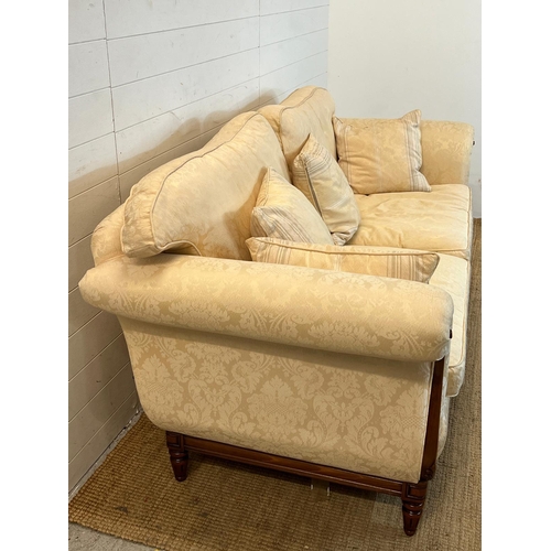 154 - A large two seater sofa with scrolling wooden frame by Medallion (H83cm W197cm D94cm SH53cm)