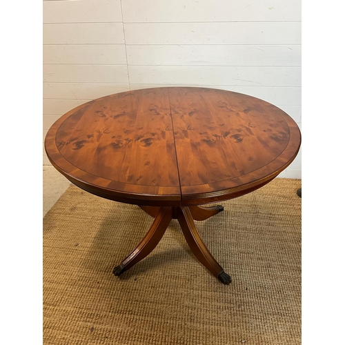 161 - Circular dining table on down swept legs and metal capped lion paw ends with four balloon back chair... 