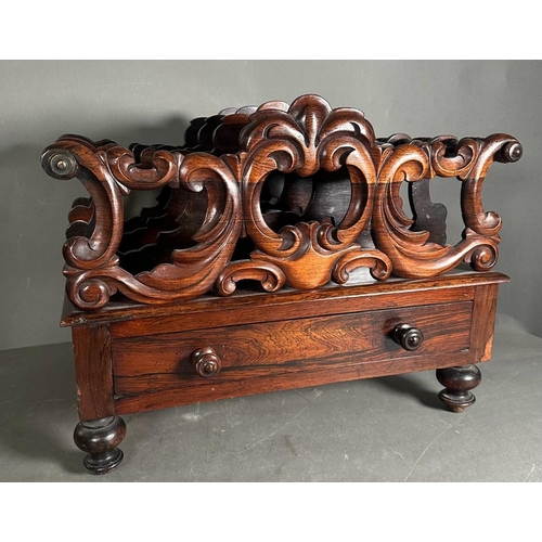 172 - A Victorian carved rosewood Canterbury on turned feet with single drawer under. (53cm x 37cm x 42cm)