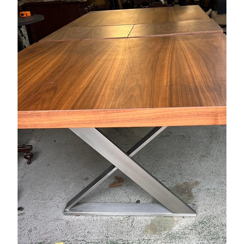 174 - An expanding dining table with brushed steel X frame legs