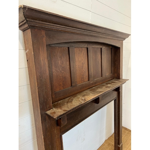 18 - An oak panelled fire surround 183cm x 142cm