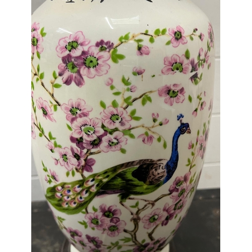 180 - A table lamp decorated with a peacock and cherry blossom