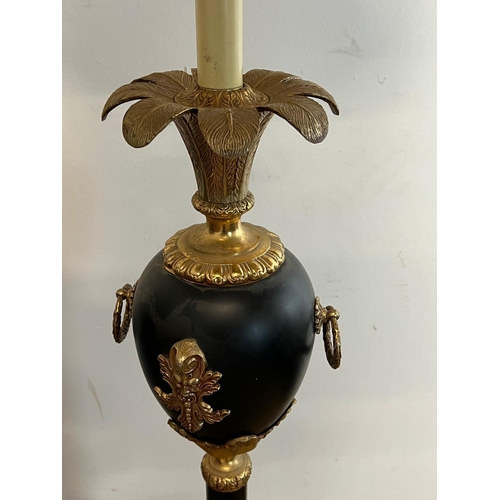 189 - A brass and ebonized standard lamps on lion paw feet (H190cm)