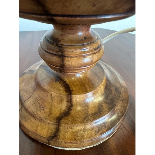 198 - An African style wooden carved table lamp with a lion banded relief