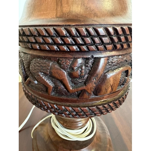 199 - An African style wooden carved table lamp with a tribal banded relief