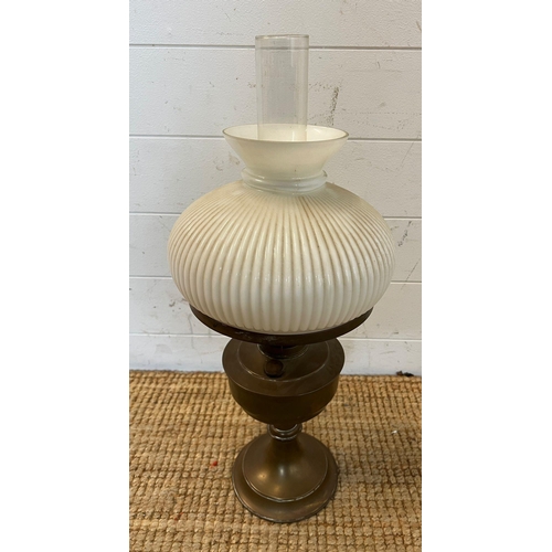 203 - A brass and ribbed glass oil lamp