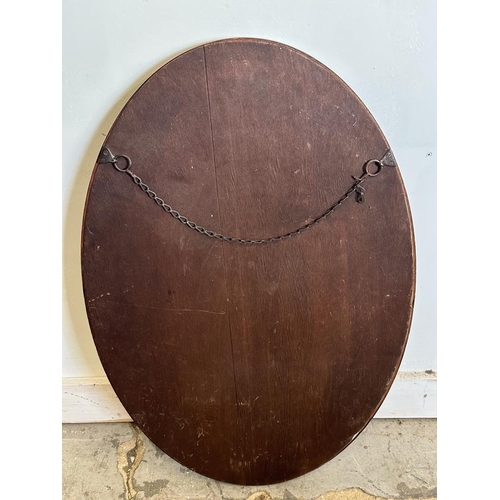 208 - An oval mahogany framed bevel edged hall mirror 80cm x 54cm