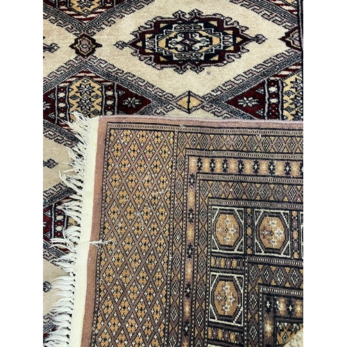 215 - A Pakistani style geometric tug, twelve diamond motifs to centre 180cm x 125cm