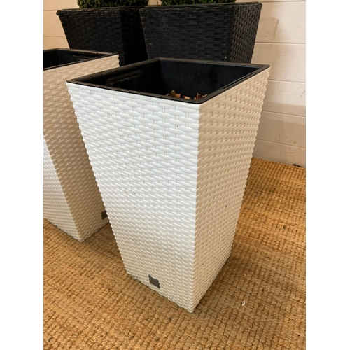 232 - Four rattan planters, two black (H60cm) and two white (H50cm)