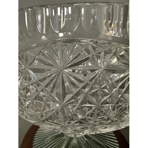 242 - A lead crystal cut stemmed punch bowl on a mahogany plinth