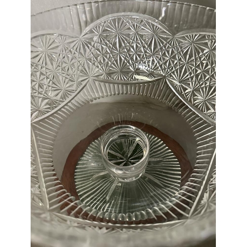 242 - A lead crystal cut stemmed punch bowl on a mahogany plinth