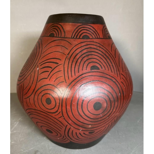 255 - An Indonesian gourd shaped vase, red ground with a swirling black pattern (H35cm)