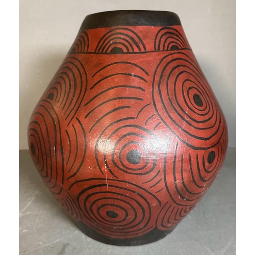 255 - An Indonesian gourd shaped vase, red ground with a swirling black pattern (H35cm)