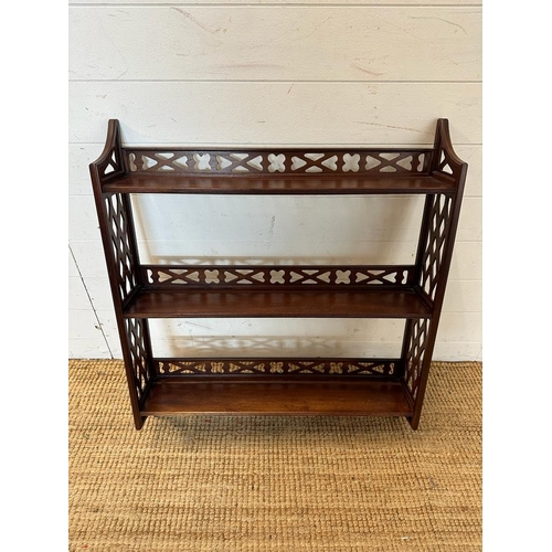 26 - A mahogany three shelf wall hanging bookcase with piece sides and back rail.